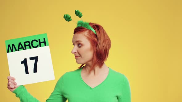 Woman showing calendar with a date for Saint Patrick's Day
