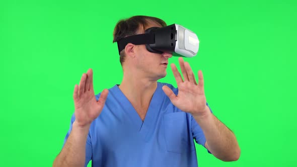 Medical Man with Virtual Reality Headset or 3d Glasses. Green Screen