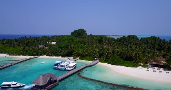 Natural drone island view of a white sand paradise beach and aqua blue water background