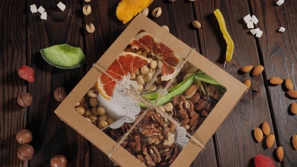A Gift Set of Various Nuts and Dried Fruits on a Wooden Surface