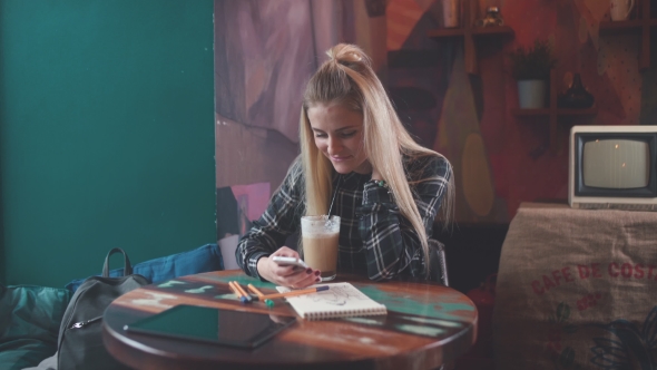 Girl in Cafe Uses a Wi-fi for SMS, Social Networks.