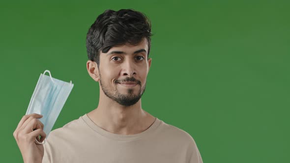 Arab Man Young Guy Hold in Male Hand Blue Face Mask Medical Protective Veil From Viral Coronavirus