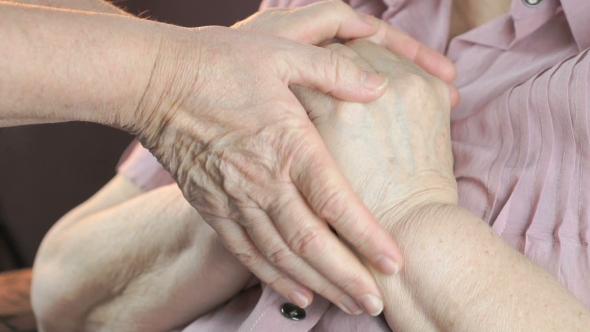 Woman Holding Flabby Wrinkled Hands of Old Woman