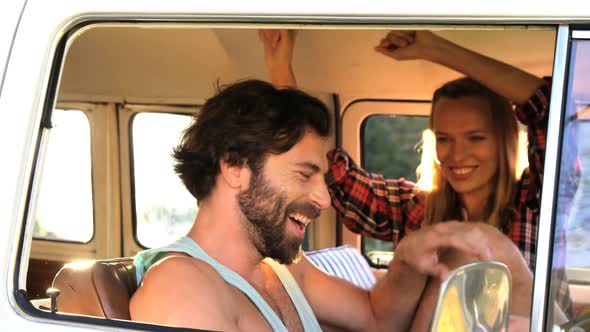 Hipster couple dancing in the van