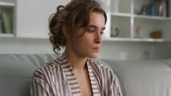 Thinking Woman Considering Answer Resting on Couch in Living Room Closeup