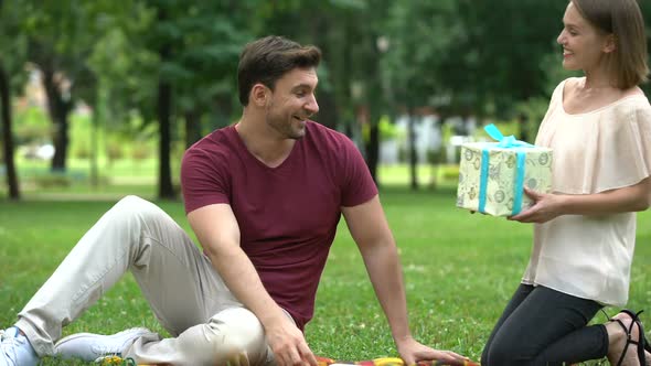 Wife Gives Present to Beloved Husband, Celebration of Birthday or Anniversary