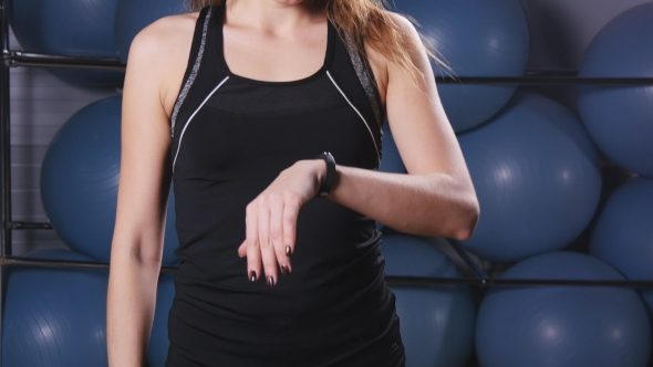 Smart Watch Showing a Heart Rate of Exercising Woman in Gym
