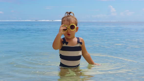 Adorable Little Girl on Warm and Sunny Summer Day on the Coastline Indian Ocean