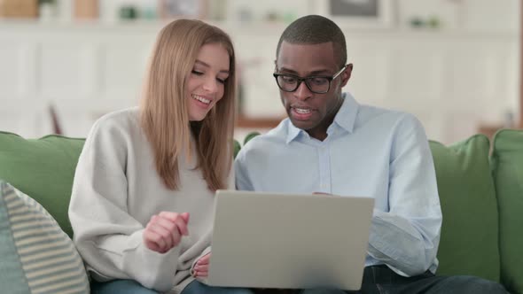 Mixed Race Couple Working on Laptop at Home