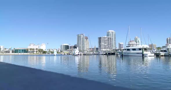 4K Video of Small Sailboat Sailing Past Yachts in Florida Marina