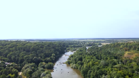 Aerial view of Southern Bug river and granite mountains, summer landscape of forest on the shore