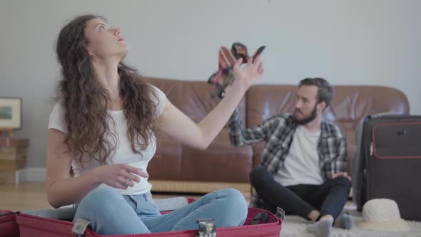 Portrait Happy Man and Woman on the Floor Packing a Suitcase Before Travel at Home