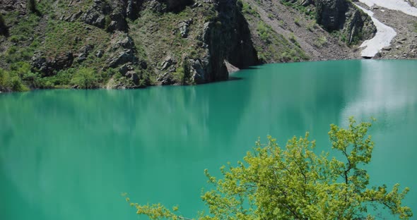Mountain Lake of green and blue color Urungach. Located in Uzbekistan, Central Asia. 5 out of 10
