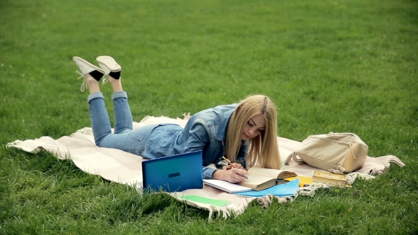 Pretty Student Making Notes in the Tutorial.