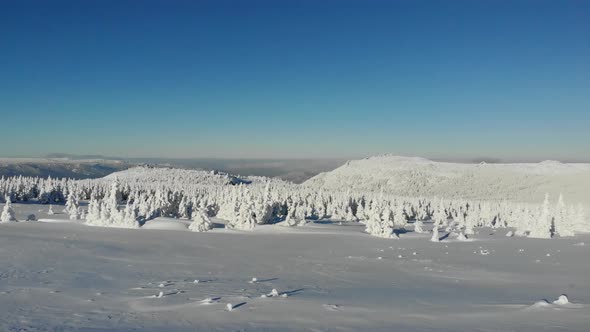 Aerial View of Snowcapped Mountain Peak in Winter