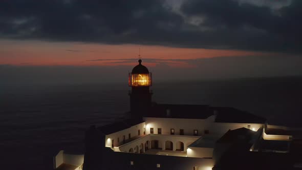 Aerial Circling Around Sensational Lighthouse in Lagos Algarve Portugal Light Flashing at Dusk
