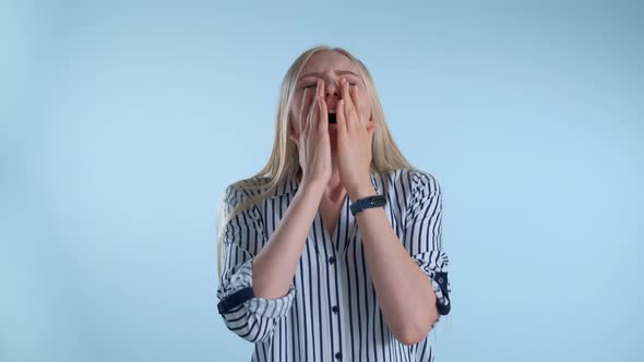 Young Blonde Woman Sneezing and and Wiping Her Nose