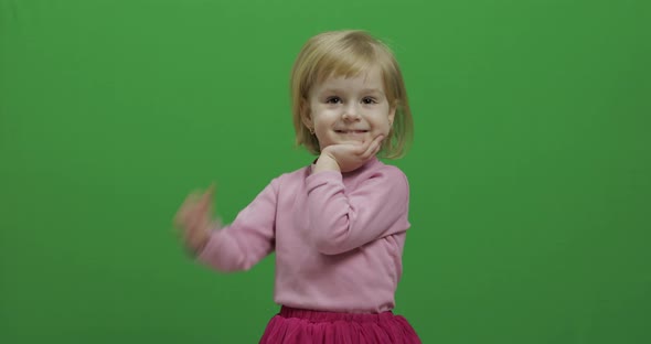 Happy Three Years Old Girl. Cute Blonde Child. Dancing and Make Faces