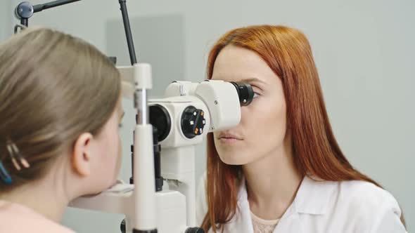 Pediatric Optician Checking Eyes of Girl