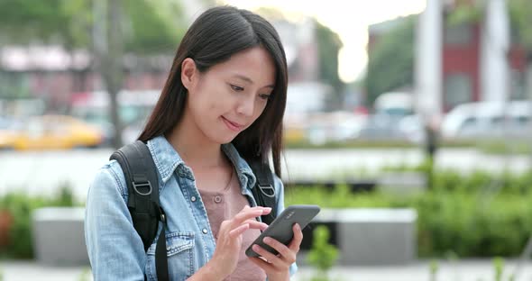 Woman travel in the city of Taiwan, use of mobile phone at outdoor