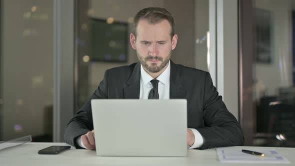 Upset Businessman Get Disappointed in Office at Night