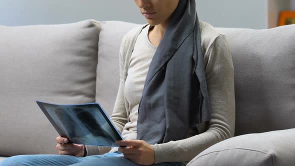 Depressed Cancer Patient Looking at Xray Image, Deterioration After Chemotherapy