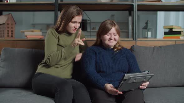 Lovely Deaf Females Making Video Call on Tablet Pc