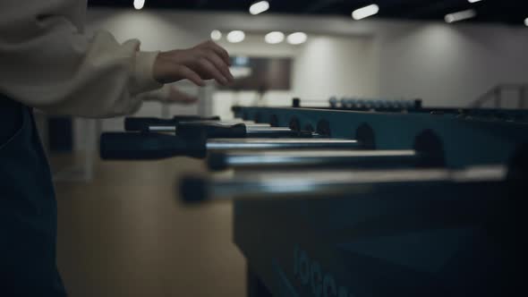 Girl Hands Grasping Table Football Rods Close Up