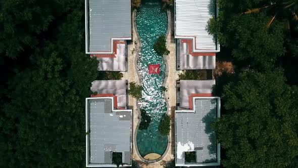 Fantastic aerial flight drone shot from above of a one guy in a pool of a luxury resort hotel on a s