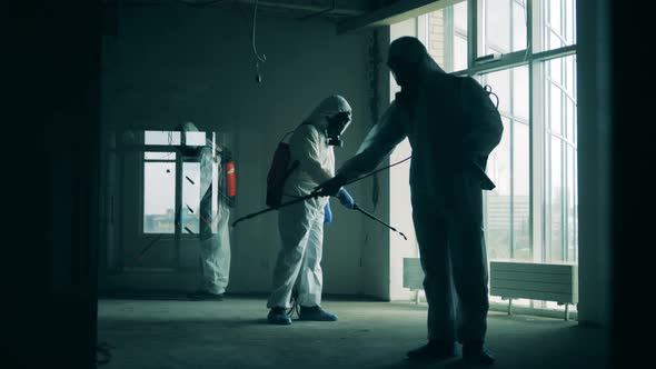 Disinfectors Spray Antiseptic in a Room.