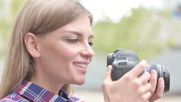 Beautiful Woman Photographer Smiling While Holding Camera