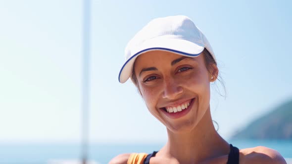 Camera Zooming To Happy Smiling Young Woman in White Cap