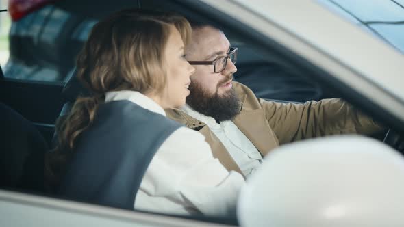 A Married Couple in the Salon of a New Car