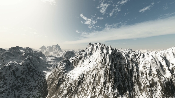 Mountains in Snow and Clouds at Blue Sky