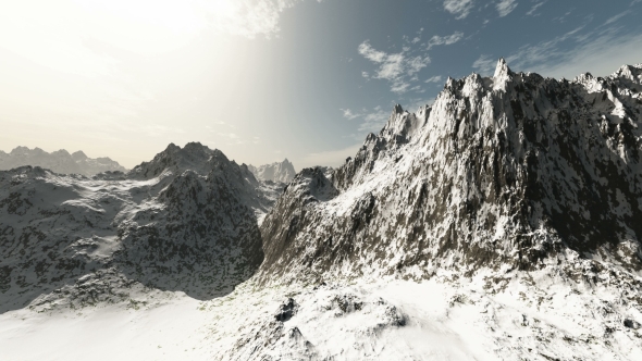 Mountains in Snow and Clouds at Blue Sky