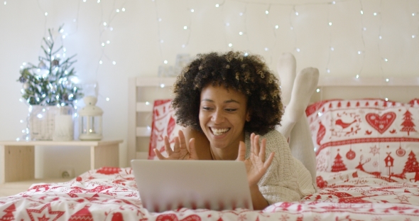 Gorgeous Young Woman in Bed with Computer