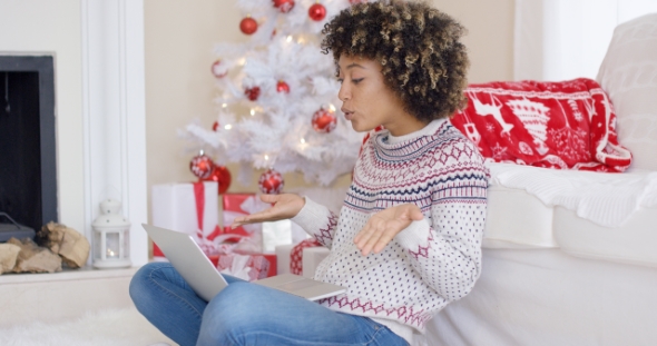 Cute Young Woman Having a Video Chat at Christmas