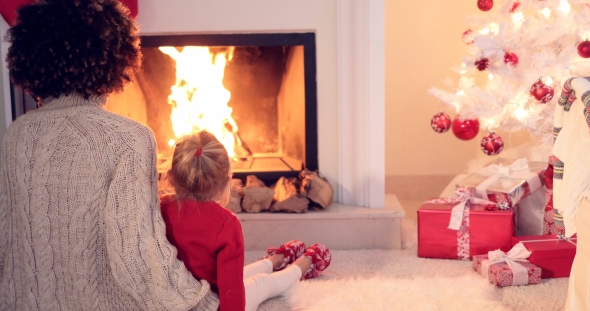 Mother and Child Warm Up By the Fireplace