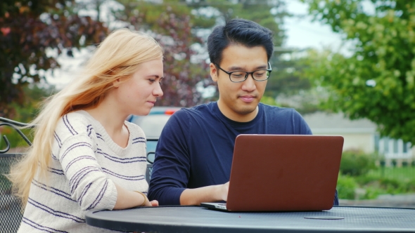 Multiethnicity Young Friends Working with Laptop. Smile, Have a Good Time