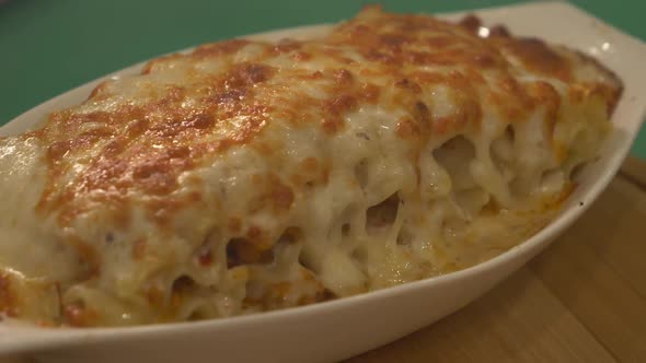 Close Up Lasagna In White Bowl. Slowly Rotating