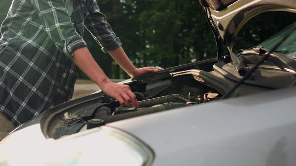 Breakdown Of The Car Open The Hood Of The Car Girl Driver Checks The Condition Of The Engine While