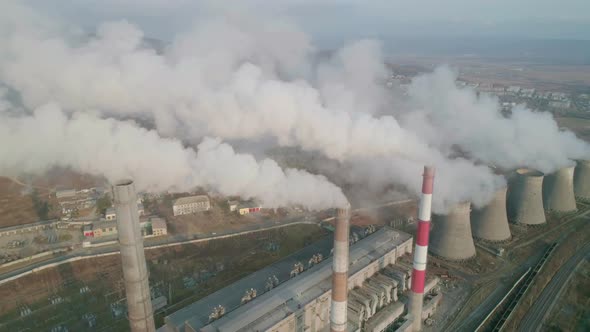 Aerial Drone View of Tall Chimney Pipes with Grey Smoke From Coal Power Plant