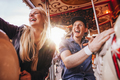 Smiling couple on carousel at fairground - PhotoDune Item for Sale