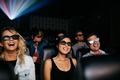 Friends watching 3d movie in theater and laughing - PhotoDune Item for Sale