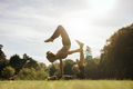 Healthy young couple doing acro yoga outdoors - PhotoDune Item for Sale