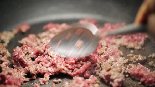 Minced Meat Being Mixed in a Pan By Spoon