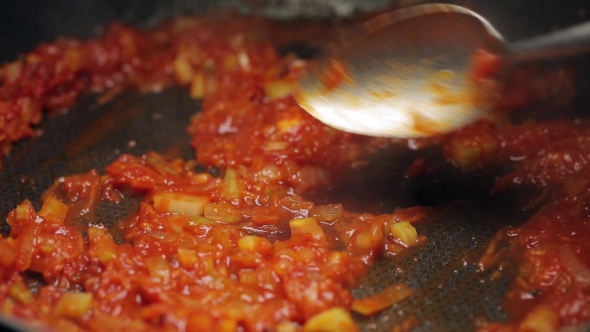 Minced Vegetables Being Mixed in a Pan By Spoon