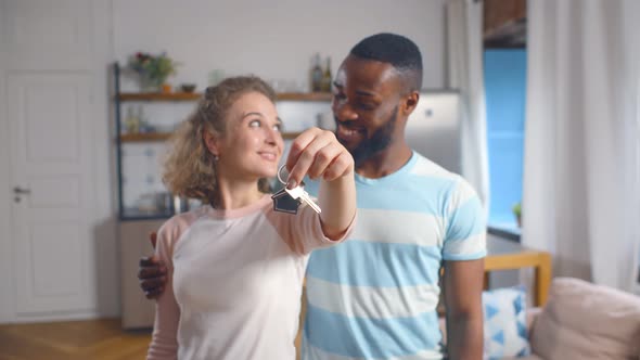 Happy Young Multiethnic Couple with Keys To New Home