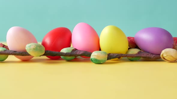 Easter Concept with Multi Color Eggs and Flower on Table