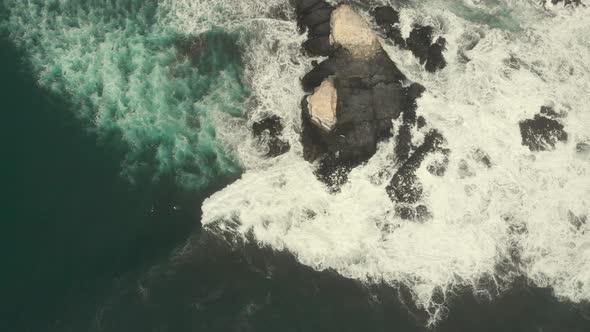 Waves hitting rocky formations from above, Aerial Shot, Pichilemu, Chile.4K